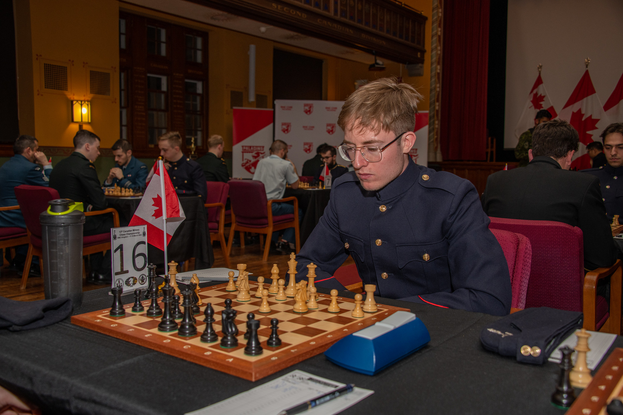 A First-Year N/OCdt playing during a Canadian Military Chess Championship in historic Currie Hall on campus.