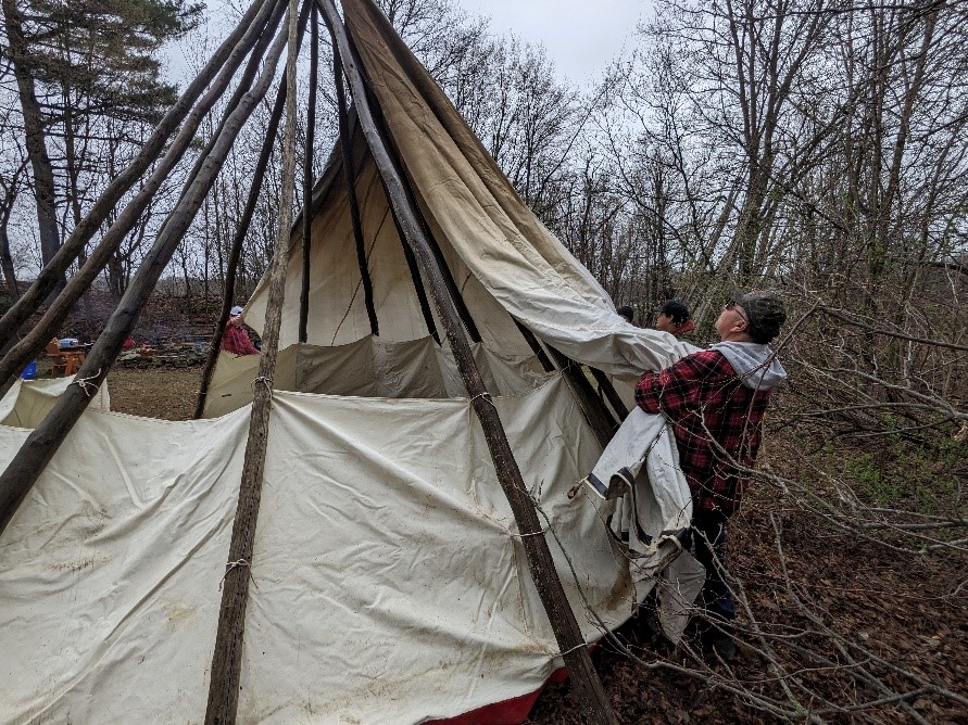 The ILOY elder teaches how to raise a tipi