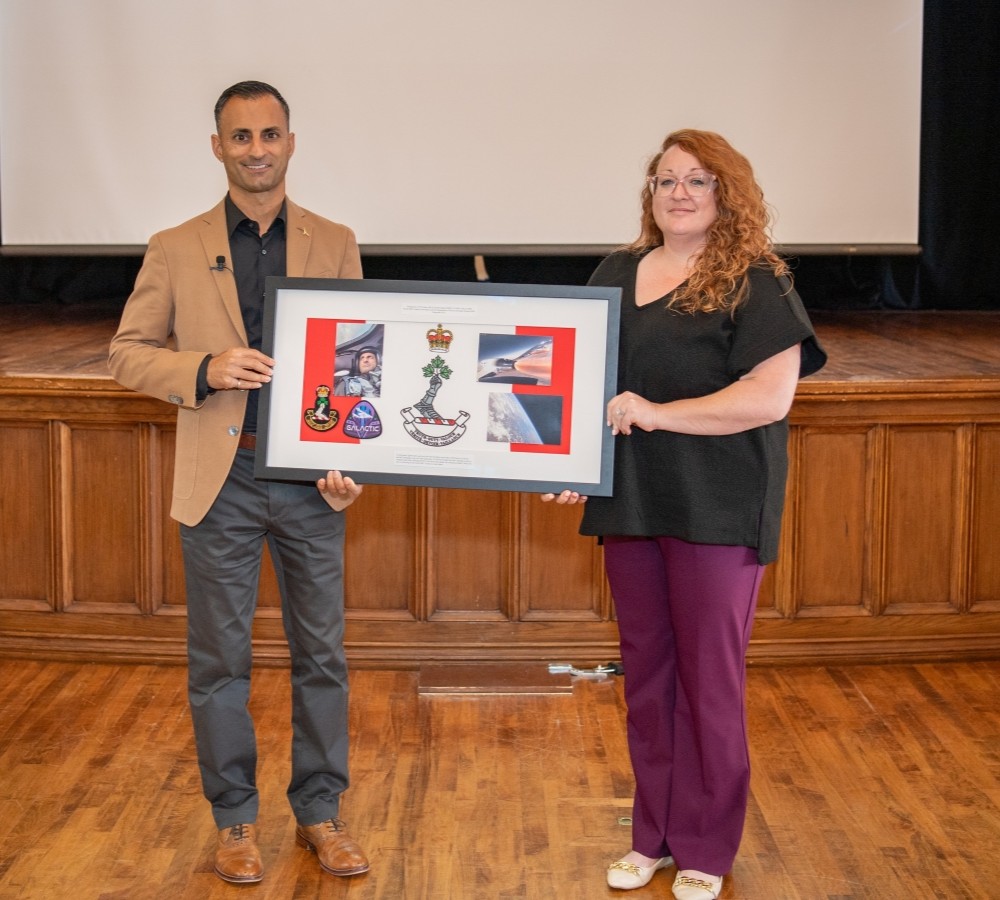 RMC Alumni Association Representative Ms. Jennifer Jordan presented Maj (Ret) Jameel Janjua with a display box containing the RMC crest and mission patch he flew with him to space on board the Virgin Galactic VSS Unity on 8 June 2024. The display box will be held by the RMC Alumni Association at Panet House.